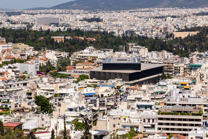 Cityscape of Athens, Greece, including The Acropolis Museum, seen from Philopappou Hill.