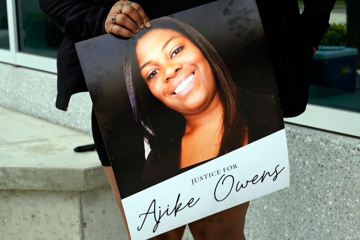 A protester, holds a poster of Ajike Owens at the Marion County Courthouse, Tuesday, June 6, 2023, in Ocala, demanding the arrest of a woman who shot and killed Owens, a 35-year-old mother of four, last Friday night.