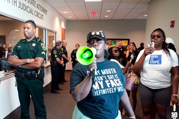 Protesters gather in outside the state attorney's office at the Marion County Courthouse.