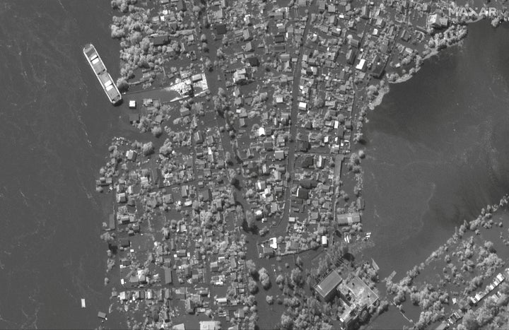 A satellite image shows flooded homes along Dnipro River southeast of Kherson, Ukraine, June 6, 2023.