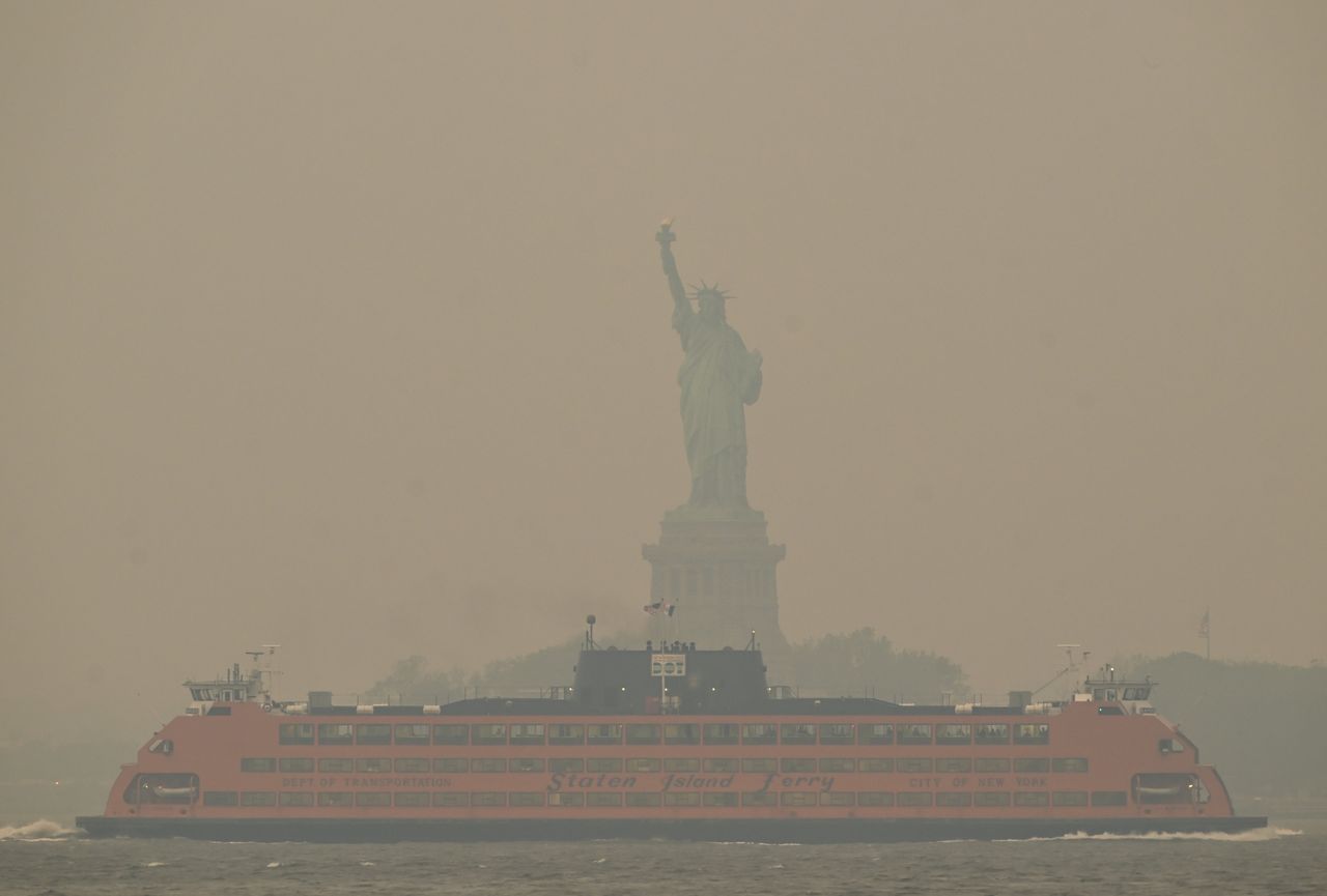 The Downtown Manhattan skyline stands shrouded in a reddish haze as a result of Canadian wildfires on Tuesday. 