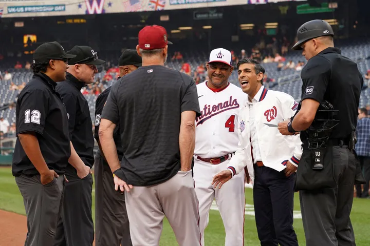 British Prime Minister Rishi Sunak poses with Washington Nationals mascot  Screech as he attends a Washington Nationals baseball game during his  visit to Washington, Wednesday, June 7, 2023. (Kevin Lamarque/Pool Photo via