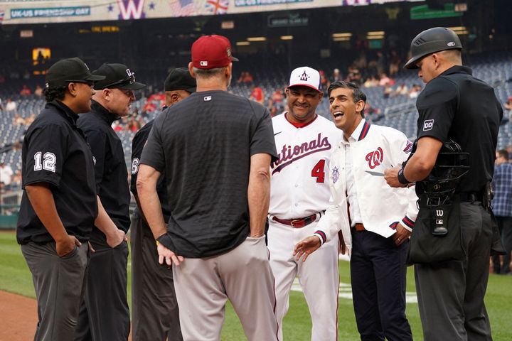 Rishi Sunak speaks with Washington Nationals manager Dave Martinez and umpires prior to the Washington Nationals baseball game at Nationals Park in Washington, DC.