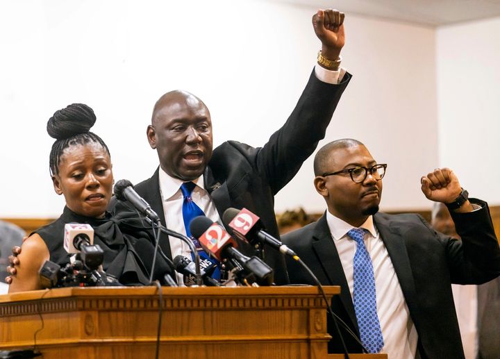 Attorney Ben Crump, center, shouts "Justice for A.J.!" while flanked by Pamela Dias, left, mother of Ajike "AJ" Owens and attorney Anthony Thomas, right, during a press conference Wednesday at the New St. John Missionary Baptist Church in Ocala, Fla.