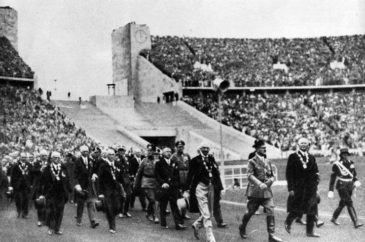 Adolf Hitler marches into the arena with entourage at the opening ceremony of the 1936 Olympic Games in Berlin.