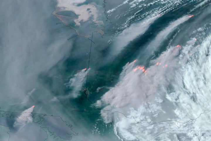 This satellite image from June 6, 2023, shows wildfires burning in the Canadian provinces of Quebec, right, and Ontario, left, with smoke drifting southward.