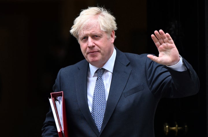 Britain's Prime Minister Boris Johnson waves as he leaves from 10 Downing Street in central London on July 5, 2022. (Photo by JUSTIN TALLIS/AFP via Getty Images)