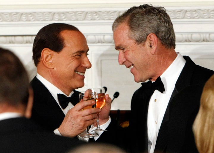 In this Monday, Oct. 13, 2008 file photo President George Bush, right, toasts with the Prime Minister of Italy Silvio Berlusconi during an Official Dinner in the State Dining Room in Washington. 