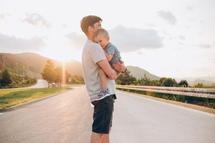 happy family. Dad holds the child in his arms and hugs him