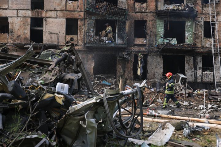Emergency workers inspect a damaged multi-storey apartment building caused by the latest rocket Russian attack in Kryvyi Rih, Ukraine, on June 13, 2023. 