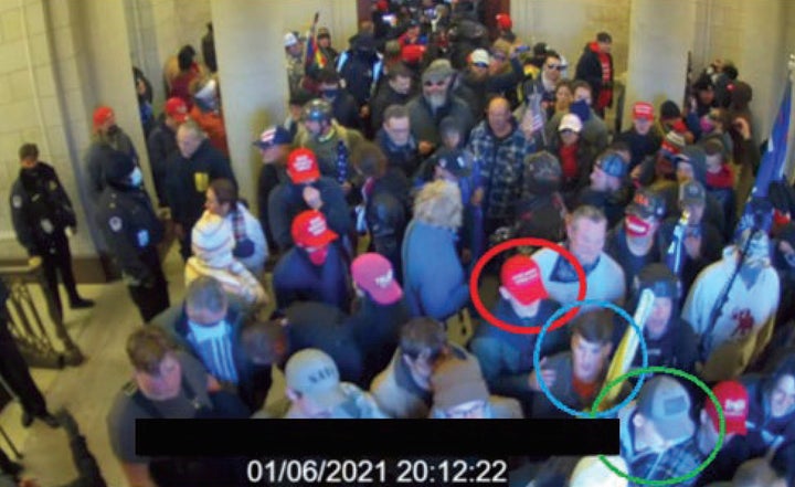 In this image from U.S. Capitol Police, Joshua Abate, circled in green, Micah Coomer, circled in red, and Dodge Dale Hellonen, circled in blue, appear inside the U.S. Capitol on Jan. 6, 2021.