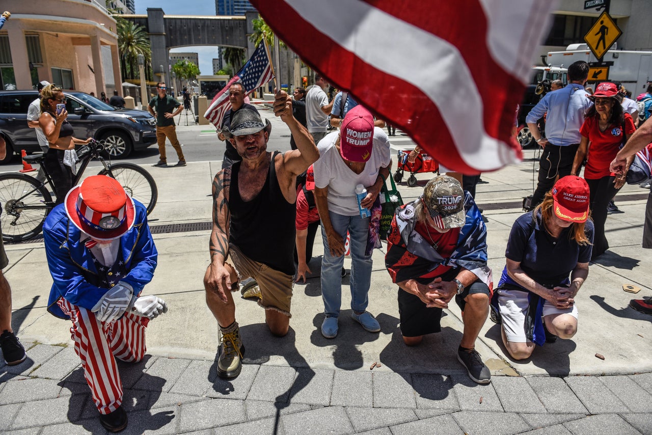 Trump supporters pray outside the federal courthouse.