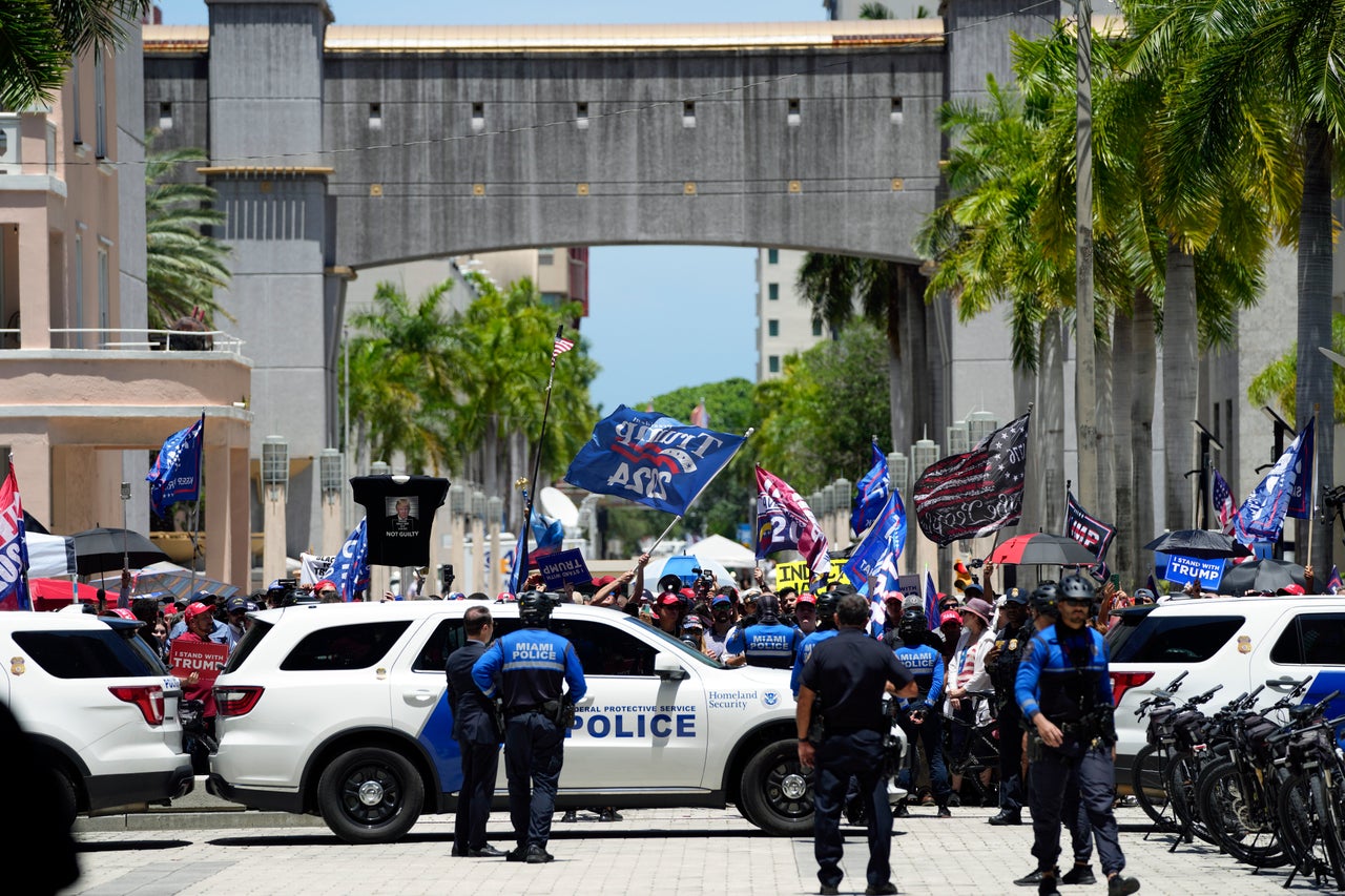 Authorities patrol outside the courthouse after Trump's arrival.