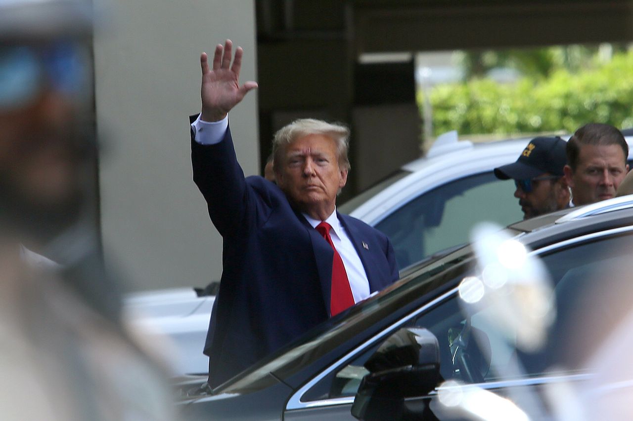 Trump waves as he makes a visit to the Cuban restaurant Versailles after he appeared for his arraignment in Miami. 