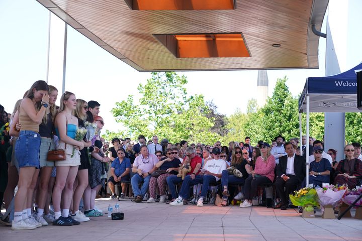 The families of Grace Kumar and Barnaby Webber (seated front) attend a vigil at the University of Nottingham after they and Ian Coates were killed and another three hurt in connected attacks on Tuesday morning.