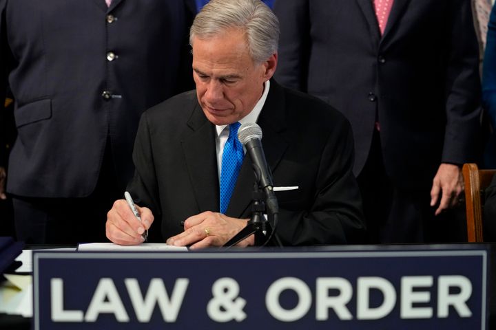 Texas Gov. Greg Abbott signs one of several Public Safety bills at the Texas Capitol in Austin on June 6. Abbott on Tuesday made it a legal requirement for public schools to have panic buttons inside classrooms.