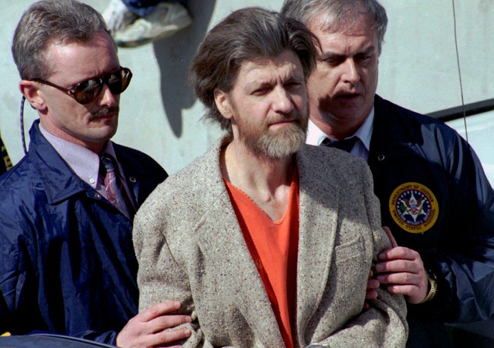 Theodore "Ted" Kaczynski flanked by federal agents as he is led to a car from the federal courthouse in Helena, Montana, on April 4, 1996.