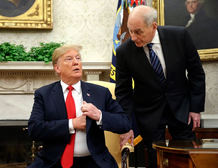 White House chief of staff John Kelly leans in to talk with President Donald Trump during a meeting with Portuguese President Marcelo Rebelo de Sousa in the Oval Office on June 27, 2018.