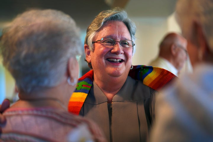 The Rev. Linda Barnes Popham, center, laughs with members of Fern Creek Baptist Church after a service, on May 21, 2023, in Louisville, Ky. In February, Fern Creek was one of five churches disfellowshipped from the Southern Baptist Convention because they have female pastors. 