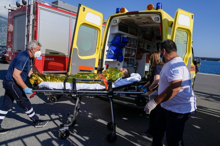 Paramedics transfer an injured survivor of a shipwreck to an ambulance at the port in Kalamata town, about 240 kilometers (150 miles) southwest of Athens, on June 14, 2023.