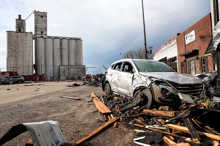 A vehicle and buildings are damaged in Perryton, Texas, after a tornado struck Thursday, June 15, 2023.