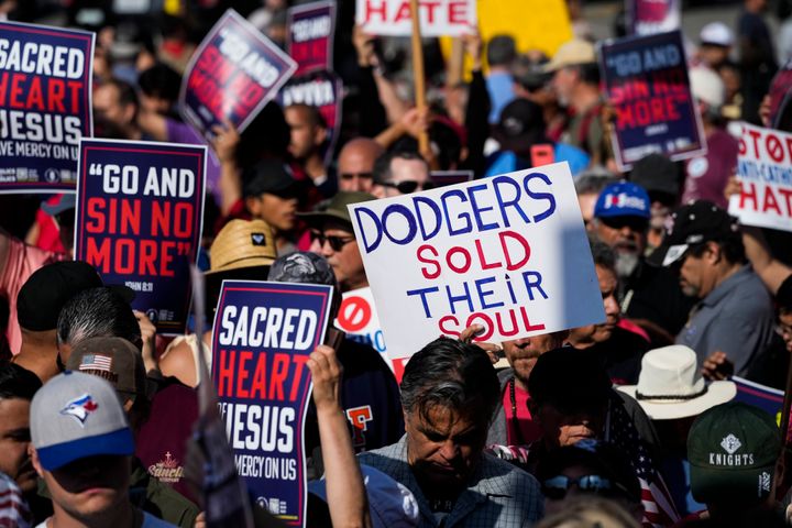 Protesters hold various signs including "Dodgers Sold Their Soul" and "Stop Anti-Catholic Hate" outside Dodger Stadium after a prayer service on Friday.