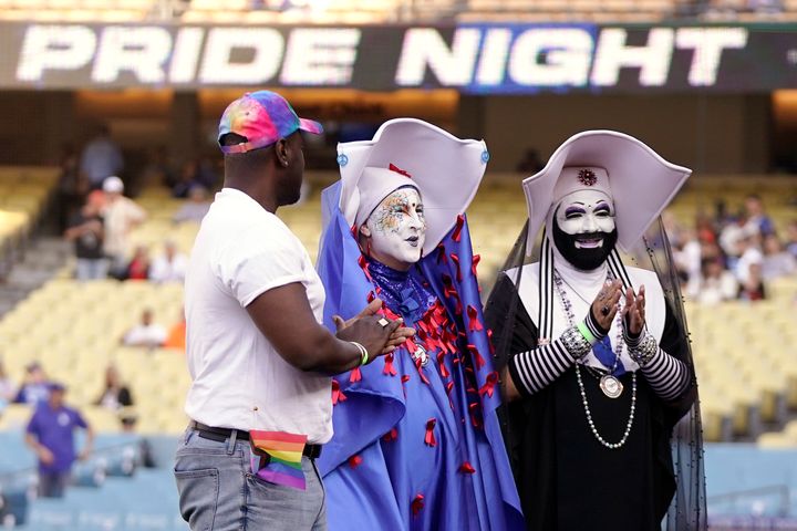 Gerald Garth (left), board president of LA Pride, stands with members of the Sisters of Perpetual Indulgence, Sister Unity (center) and Sister Dominia (right) as they honored during Pride Night prior to the Los Angeles Dodgers game against the San Francisco Giants on Friday.