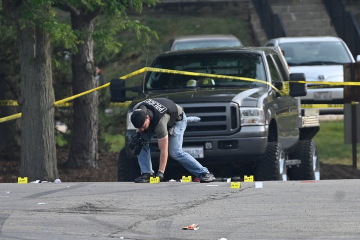 A police officer works the scene of an overnight mass shooting at a strip mall in Willowbrook, Ill., Sunday, June 18, 2023. (AP Photo/Matt Marton)