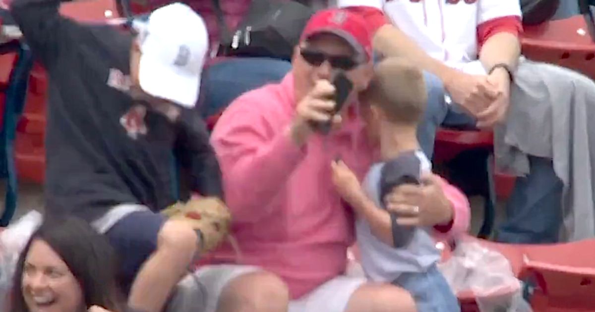 Young fan at Fenway gladly gives up ball to even younger fan