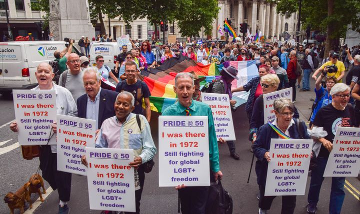 Campaigner Peter Tatchell (centre) and protesters hold placards that say "Pride at 50 - I was there in 1972" during the march outside St. Martin-in-the-Fields in Trafalgar Square.