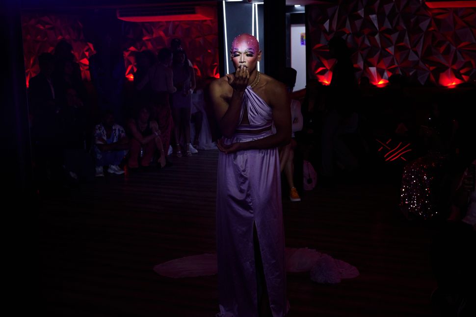 A performer lip-syncs during a ball hosted in downtown Caracas.