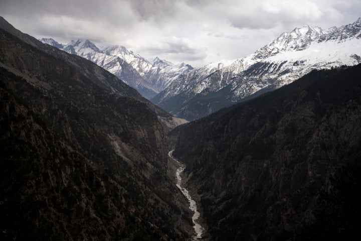 he Sutlej River flows in the valley below the tall snowy peaks in the Kinnaur district of the Himalayan state of Himachal Pradesh, India, March 13, 2023.