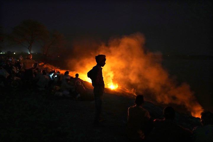 People cremate their relatives who have died from heat-related illnesses, in Ballia, in northern Indian state of Uttar Pradesh, Monday, June 19, 2023.
