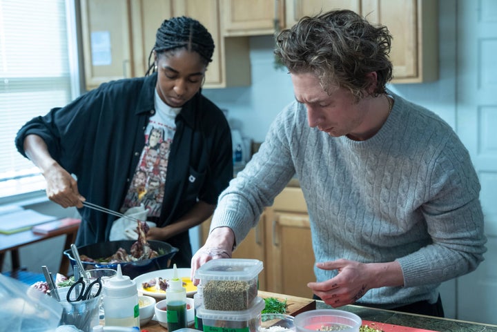 From Left: Sydney and Carmy test out recipes for the new restaurant in a scene from season two of The Bear.