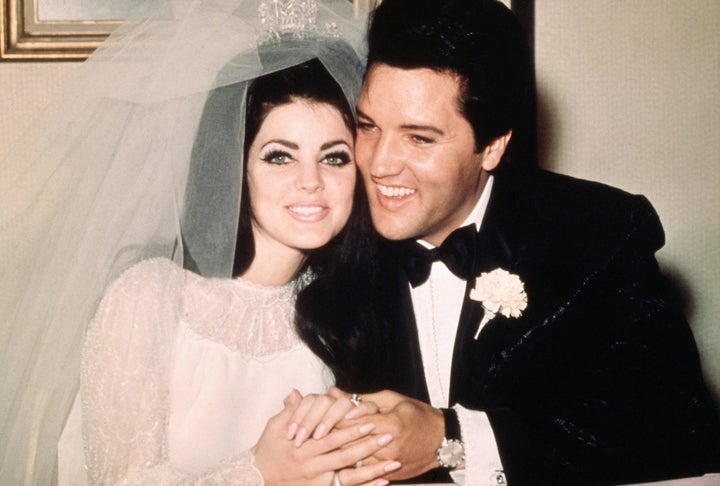 Elvis Presley sits cheek to cheek with his wife, Priscilla, in May 1967.