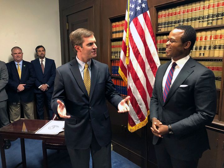 Kentucky Gov. Andy Beshear (D), left, talks to Kentucky Attorney General Daniel Cameron (R) in 2019. Cameron, a defender of the state's abortion ban, is seeking to unseat Beshear.