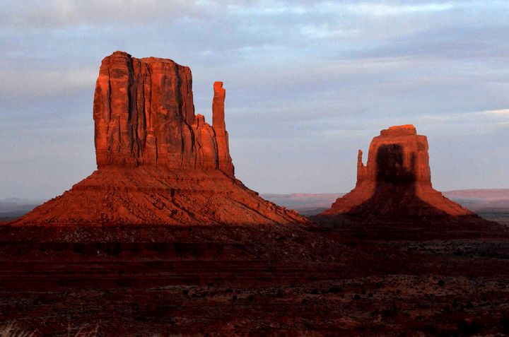 A sunset spectacle featuring two mitten-shaped rock formations played out in late March at Monument Valley on the Navajo Nation, bordering Arizona and Utah.