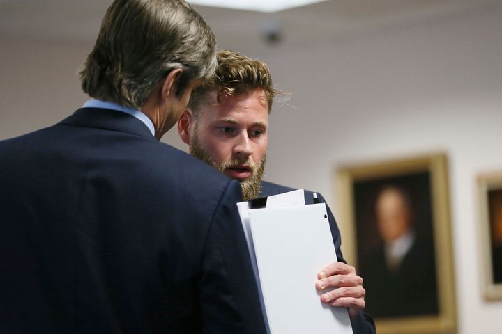 Andino Reynal, the lawyer representing Alex Jones, speaks with Owen Shroyer, an InfoWars host and sometimes reporter who is a frequent guest on the Alex Jones Show, after he testified in Jones' defamation damages trial at the Travis County Courthouse, Friday, July 29, 2022, in Austin, Texas. Jones has been found to have defamed the parents of a Sandy Hook student for calling the attack a hoax.