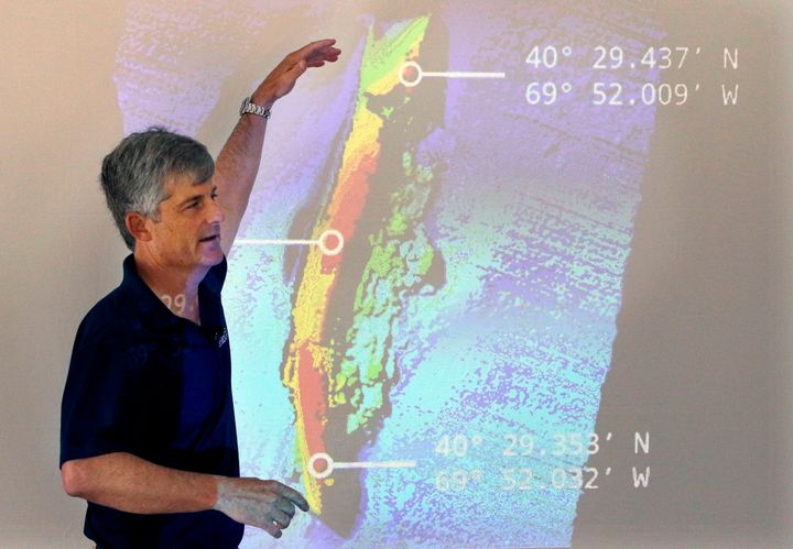 OceanGate CEO and co-founder Stockton Rush is seen in front of a projected image of the wreckage of the ocean liner SS Andrea Doria in 2016. Rush and four others were killed while venturing to the Titanic wreckage on Sunday in a submersible.