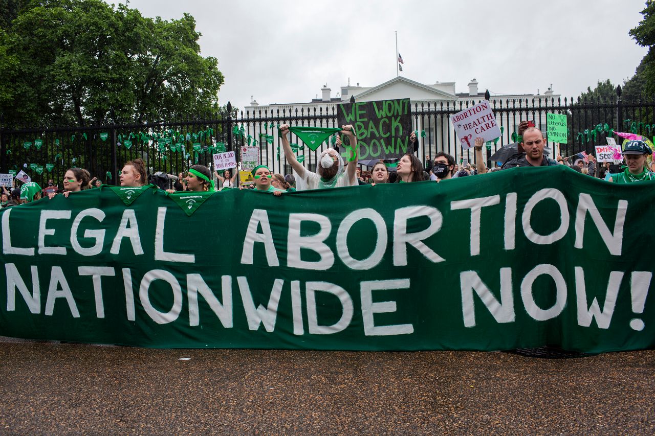 Abortion rights activists gather at the White House to denounce the U.S. Supreme Court's decision to end federal abortion rights protections.