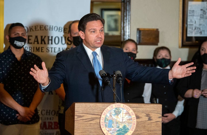 Florida Gov. Ron DeSantis vows to keep restaurants open during COVID-19 at a news conference on Dec. 15, 2020, at Okeechobee Steakhouse in West Palm Beach, Florida. DeSantis and California Gov. Gavin Newsom are sparring over the transporting of migrants to California authorized by DeSantis. (Michael Laughlin/South Florida Sun Sentinel/Tribune News Service via Getty Images)