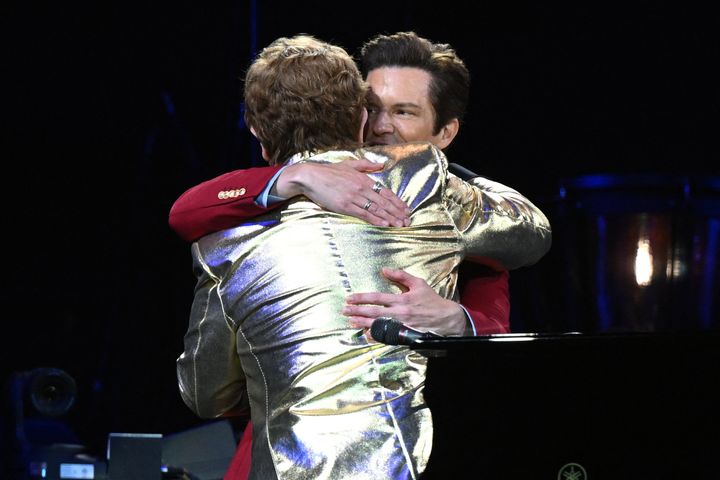Sir Elton and Brandon Flowers share a hug