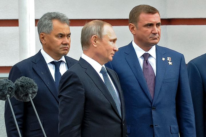 Russian President Vladimir Putin, center, flanked by Alexei Dyumin, right, acting governor of the Tula region, and Russian Defense Minister Sergei Shoigu, left, visits an exhibition at the Splav defense enterprise in Tula, about 200 kilometers (125 miles) south of Moscow, on Sept. 8, 2016.