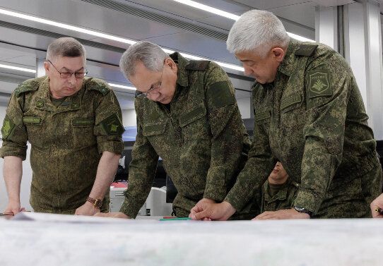 Russian Defence Minister Sergei Shoigu (C) and Yevgeny Nikiforov (R) the commander of the western military district visit the forward command post of the country's West group of forces on June 26, 2023.