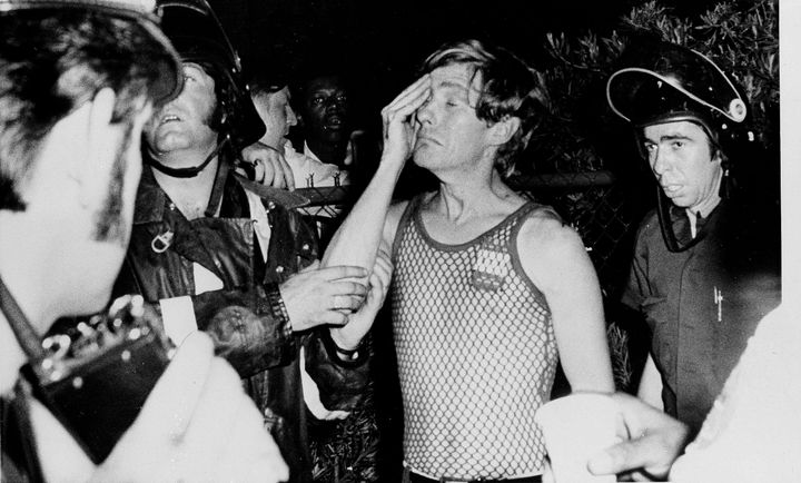 Linn Quinton weeps as he is helped by New Orleans firefighters after he escaped from a fire at the UpStairs bar on June 25, 1973. Quinton said he was with a group singing around a piano when the fire swept through the bar.