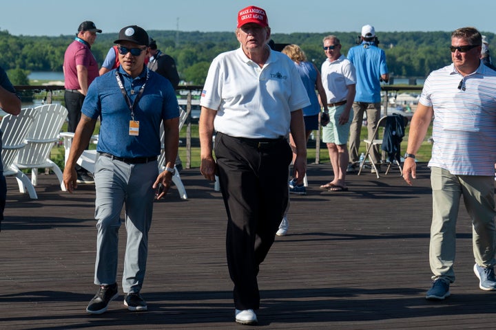 Walt Nauta, left, walks with Former President Donald Trump during the first round of the LIV Golf at Trump National Golf Club, on May 26, 2023, in Sterling, Va.