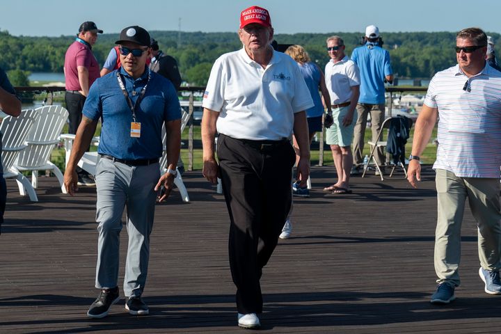 Walt Nauta, left, walks with Former President Donald Trump during the first round of the LIV Golf at Trump National Golf Club, on May 26, 2023, in Sterling, Va.