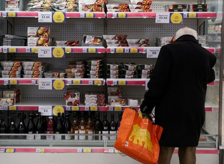 A man shops at a Tesco Extra supermarket in London.