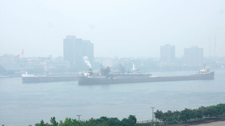 Freighters pass along the Detroit River with Windsor, Ontario in the background as smoke fills the sky reducing visibility Wednesday, June 28, 2023, as seen from Detroit. The Detroit area has some of the worst air quality in the United States as smoke from Canada's wildfires spreads southward. (AP Photo/Paul Sancya)