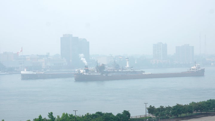 Cargo ships pass along the Detroit River with Windsor, Ontario in the background as smoke fills the sky reducing visibility Wednesday, June 28, 2023, as seen from Detroit. The Detroit area has one of the worst air quality in the United States as smoke from wildfires in Canada blows south. (AP Photo/Paul Sancya)